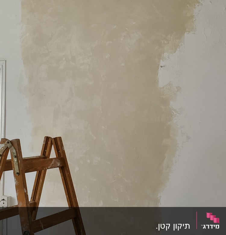 סולם עץ ליד קיר עם טיח טרי